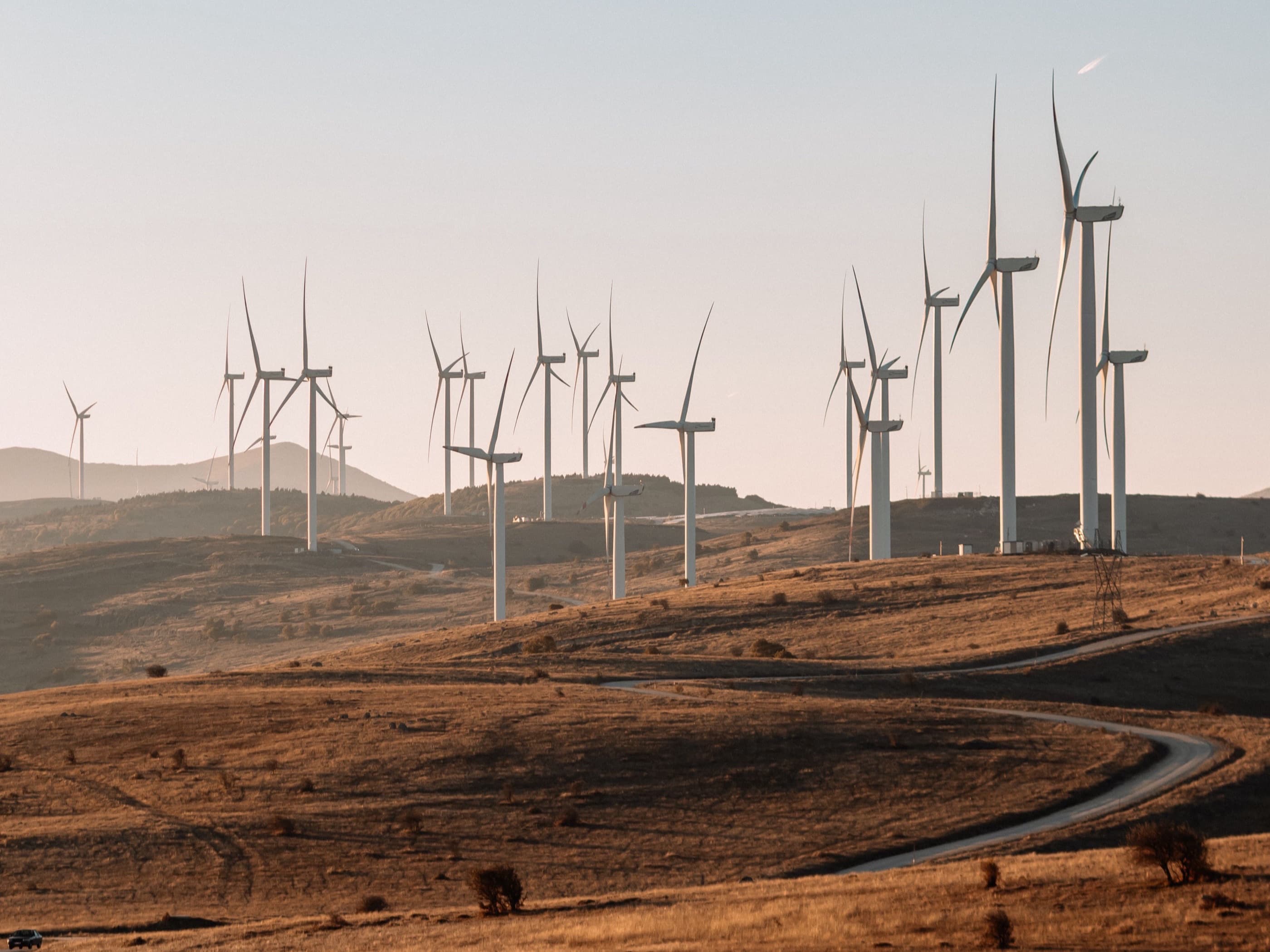 Wind turbines along a ridge at first light