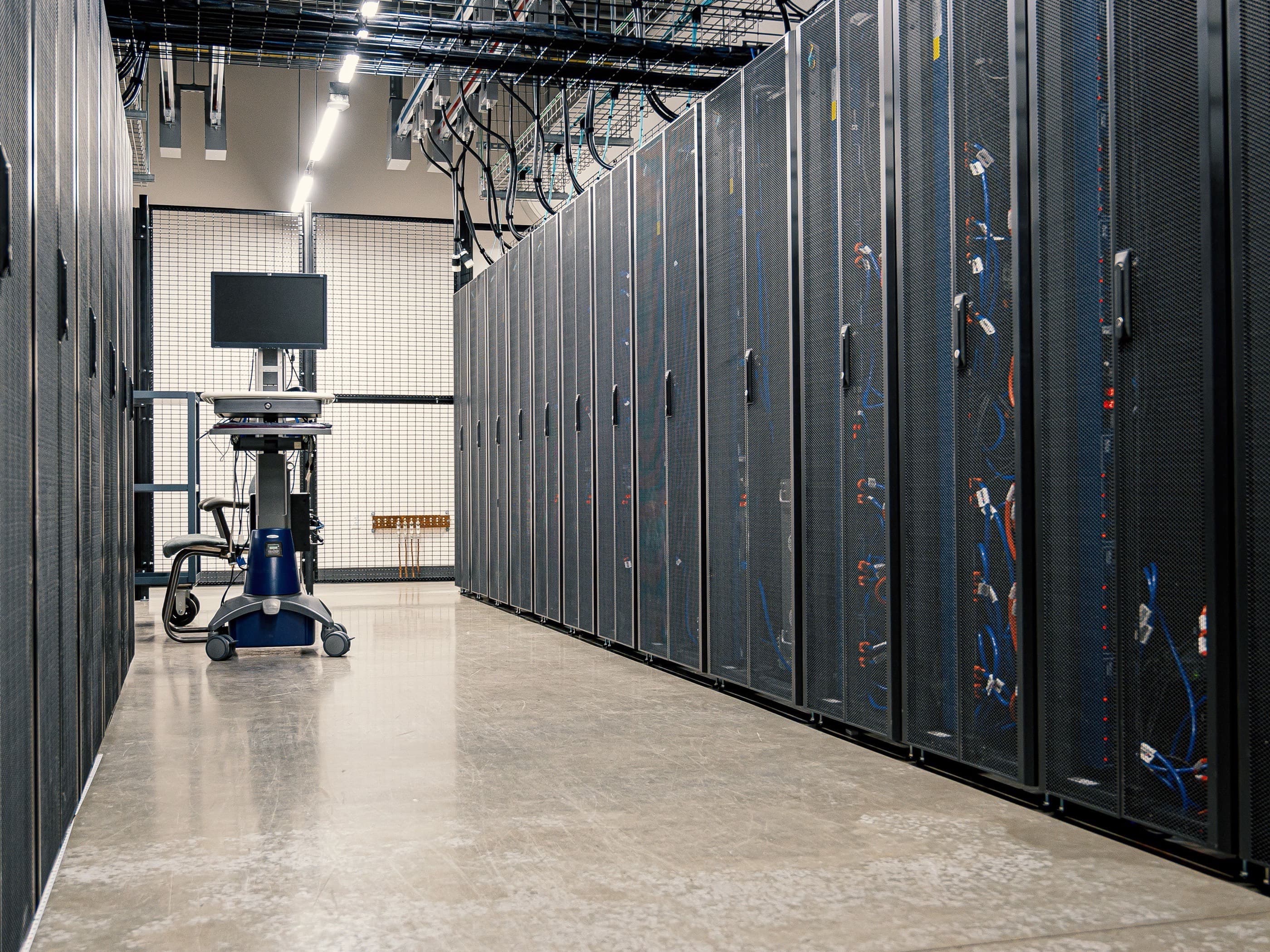 An aisle of server racks in a data centre