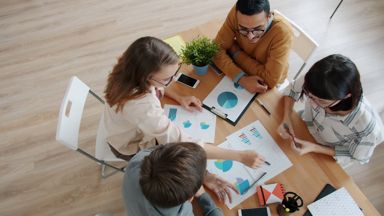 An administrative team reviewing budgets and plans around a table
